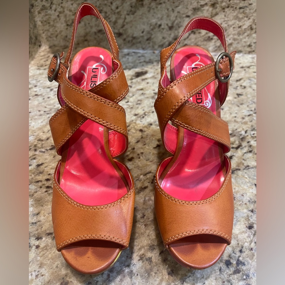 Tan wedges with very orange and pink heels. Side buckle closure.